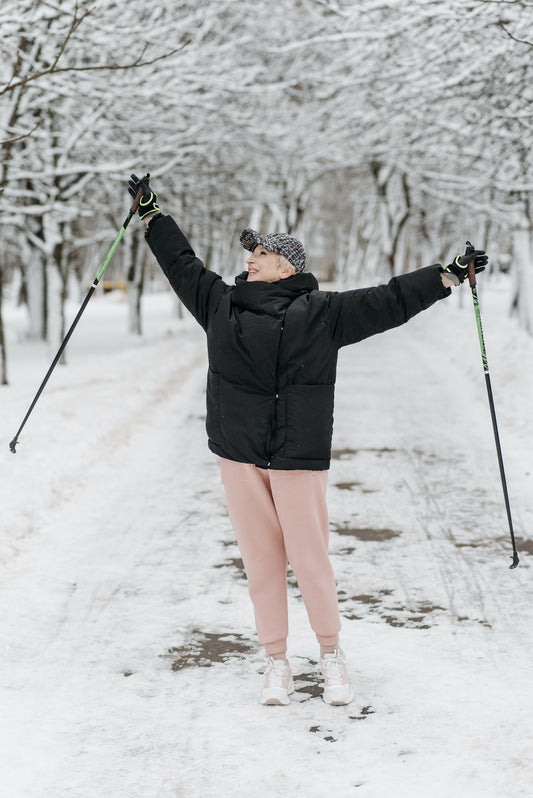 Elderly Woman with Walking ski pole in snow